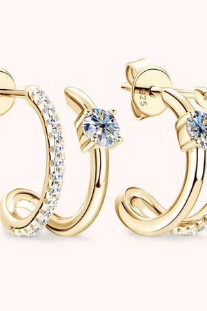 a pair of gold hoop earrings with a diamond