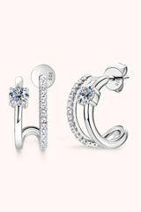 a pair of earrings with a diamond in the middle