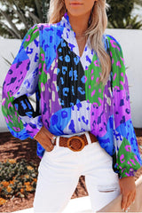 a woman wearing a colorful blouse and white jeans