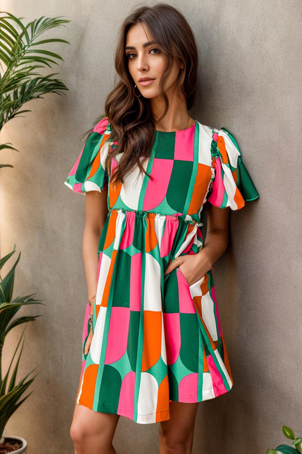 a woman standing next to a plant wearing a colorful dress