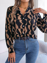 a woman wearing a black and brown shirt and jeans