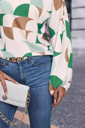 a woman in jeans and a blouse holding a white purse