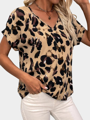 a woman wearing a leopard print top