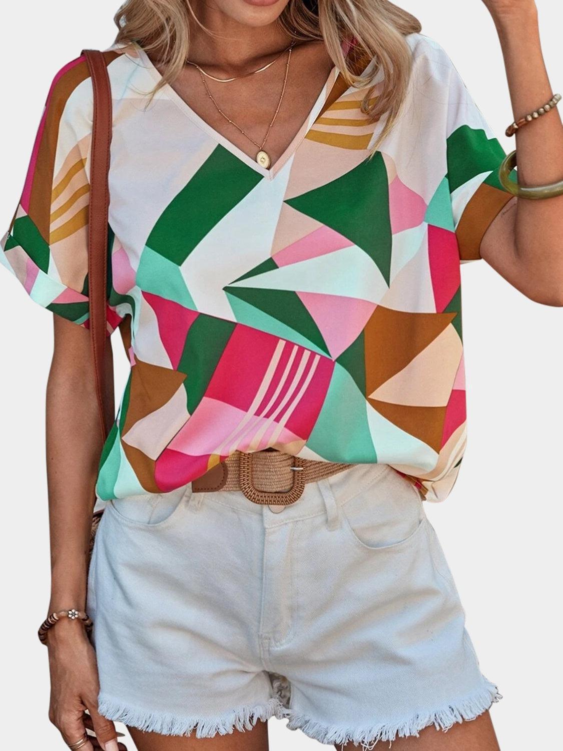 a woman wearing a colorful shirt and shorts