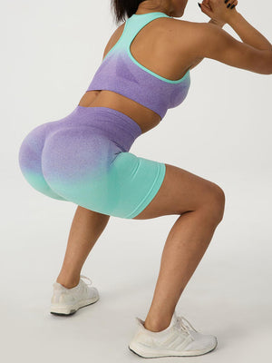 a woman in a sports bra top and shorts squatting