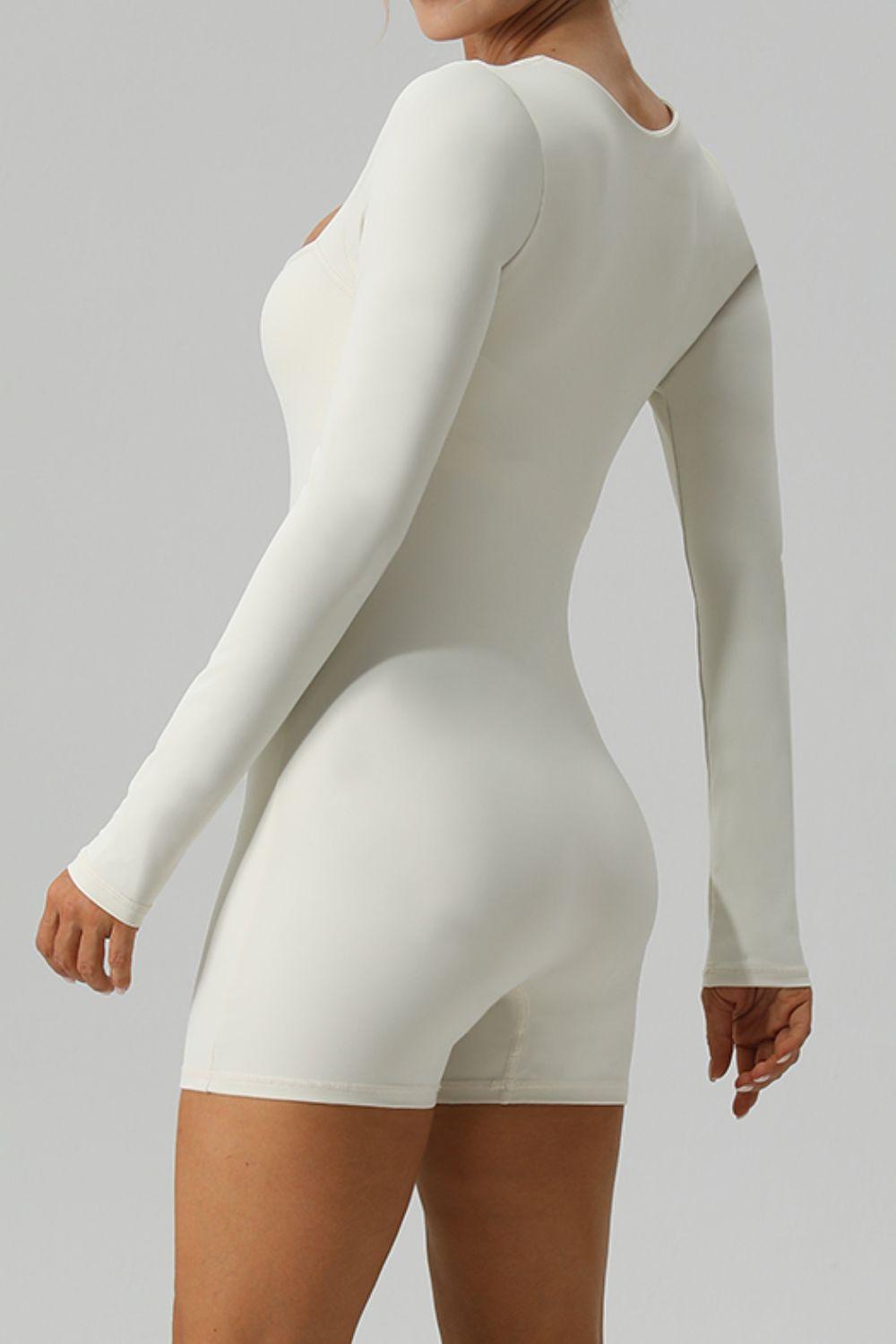 a woman in a white bodysuit posing for the camera