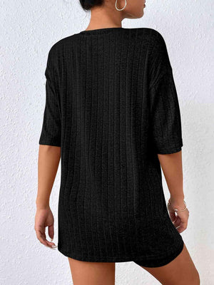 a woman wearing a black sweater dress