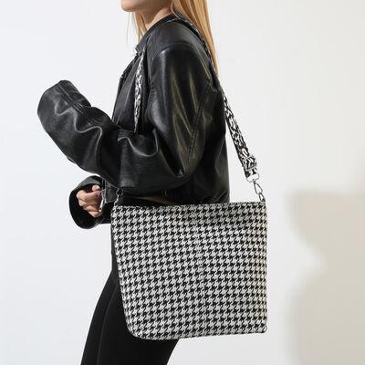 a woman carrying a black and white bag