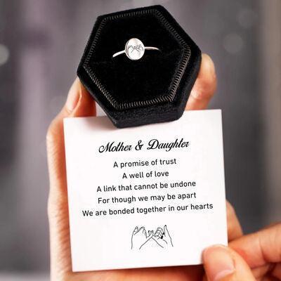 a person holding a card with a ring on it