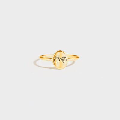 a gold ring with the word mom engraved on it