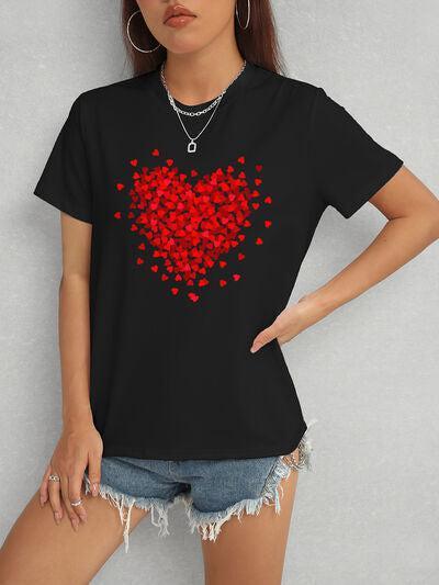 a woman wearing a black t - shirt with red hearts on it