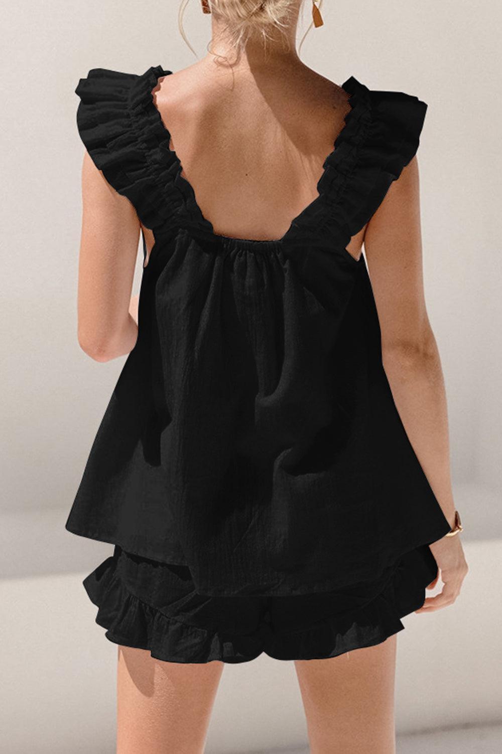 the back of a woman's black dress with ruffles