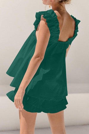 a woman in a green dress is posing for a picture