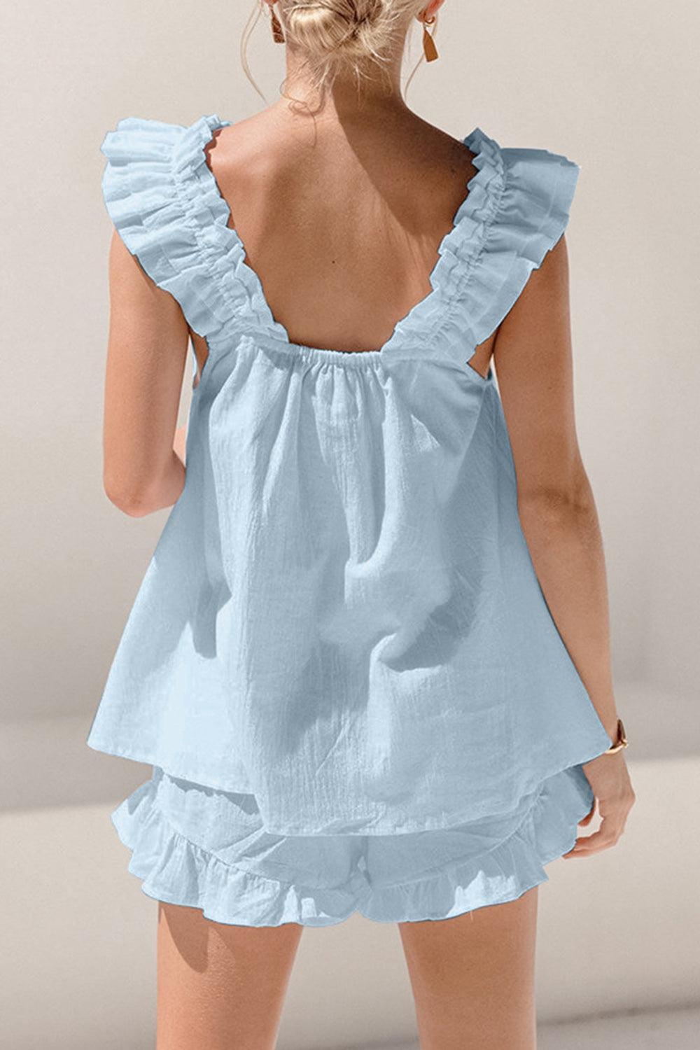 the back of a woman's blue dress with ruffles