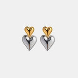 a pair of heart shaped earrings on a white background