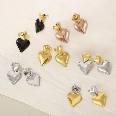 a group of heart shaped earrings sitting on top of a table