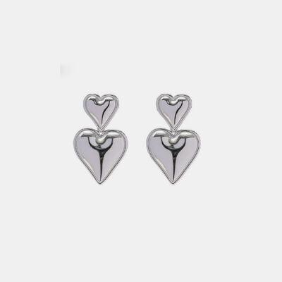 a pair of heart shaped earrings on a white background