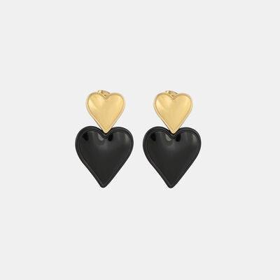 a pair of black and gold heart earrings