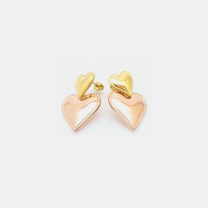 a pair of heart shaped earrings on a white background