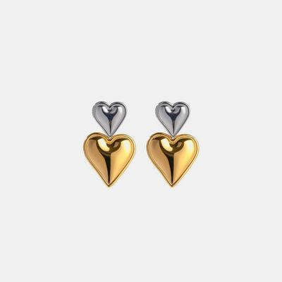 a pair of gold and silver heart earrings