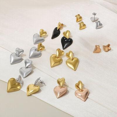 a group of heart shaped earrings sitting on top of a table