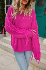 a woman wearing a pink sweater and jeans