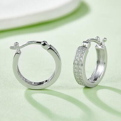 a pair of diamond hoop earrings on a table