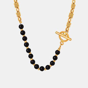 a black beaded necklace with a gold chain