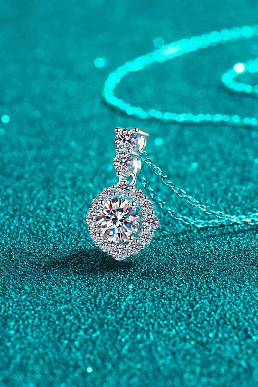 a diamond pendant on a chain on a blue background