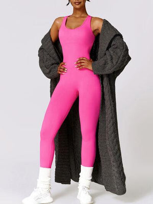 a woman in a pink jumpsuit posing for a picture