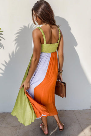 a woman in an orange, white and green dress