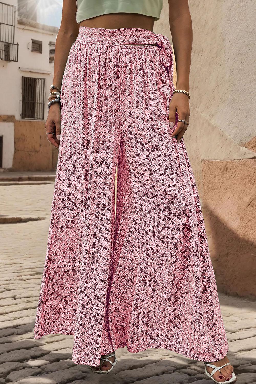 a woman standing on a cobblestone street wearing a green crop top and pink