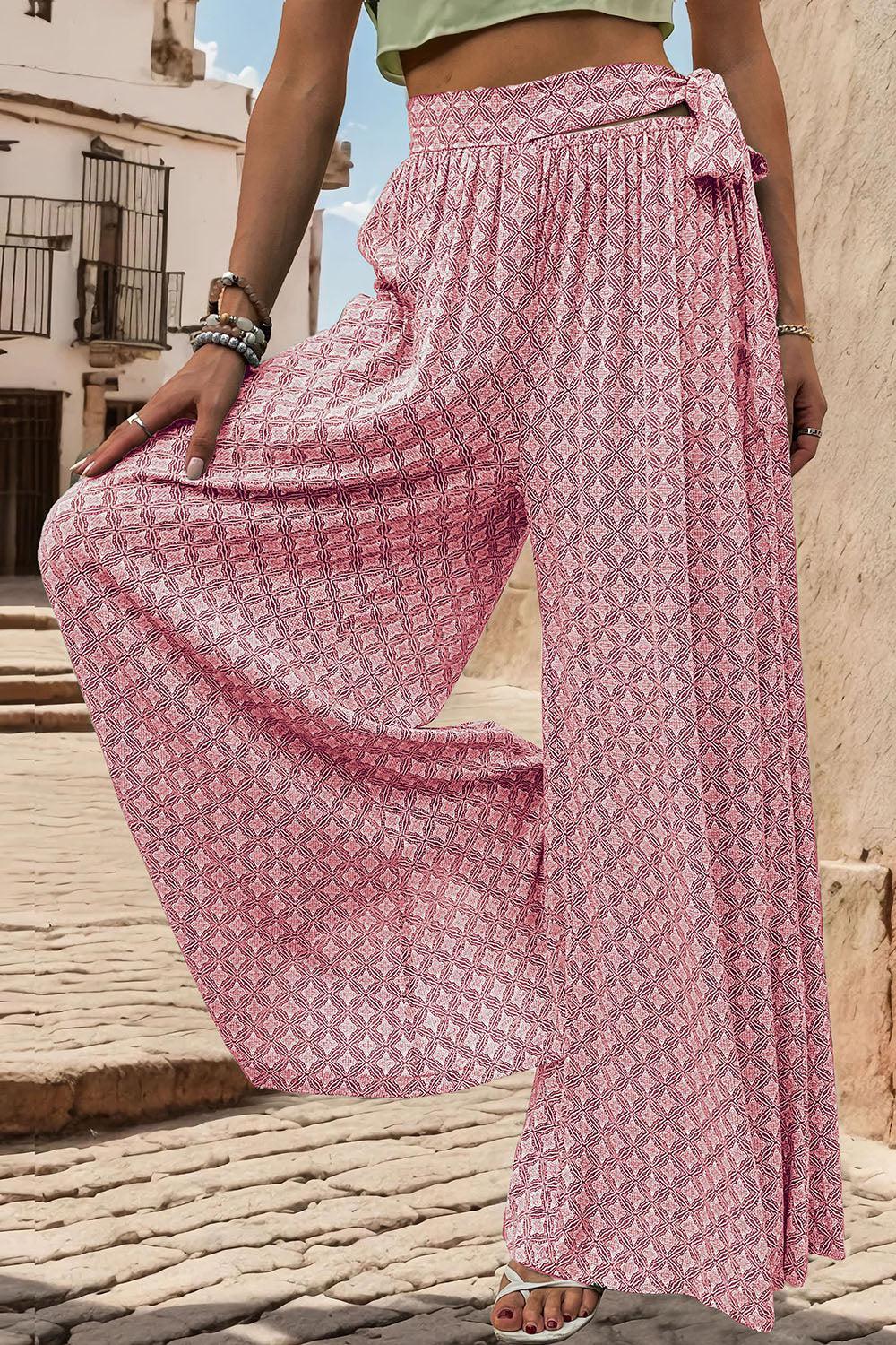 a woman in a green top and a pink skirt