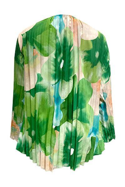 a women's blouse with green leaves on it