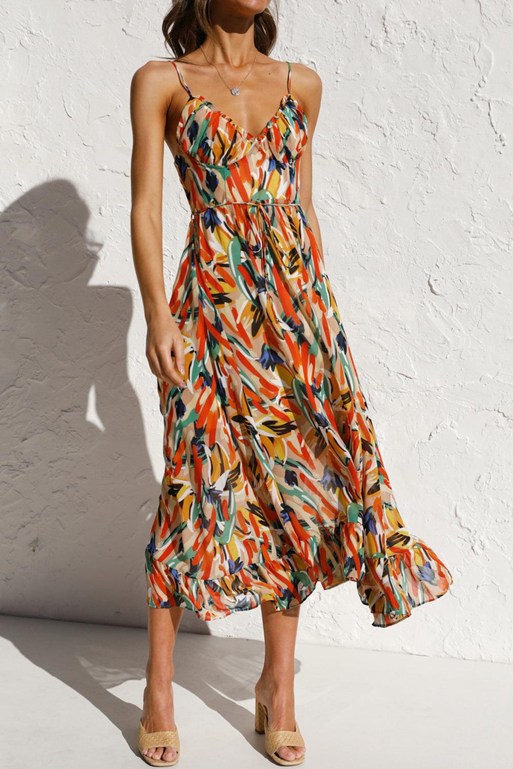 a woman in a colorful dress standing in front of a white wall