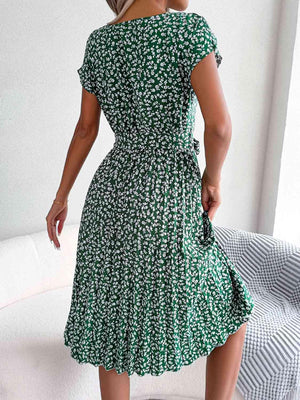 a woman in a green dress standing in a room