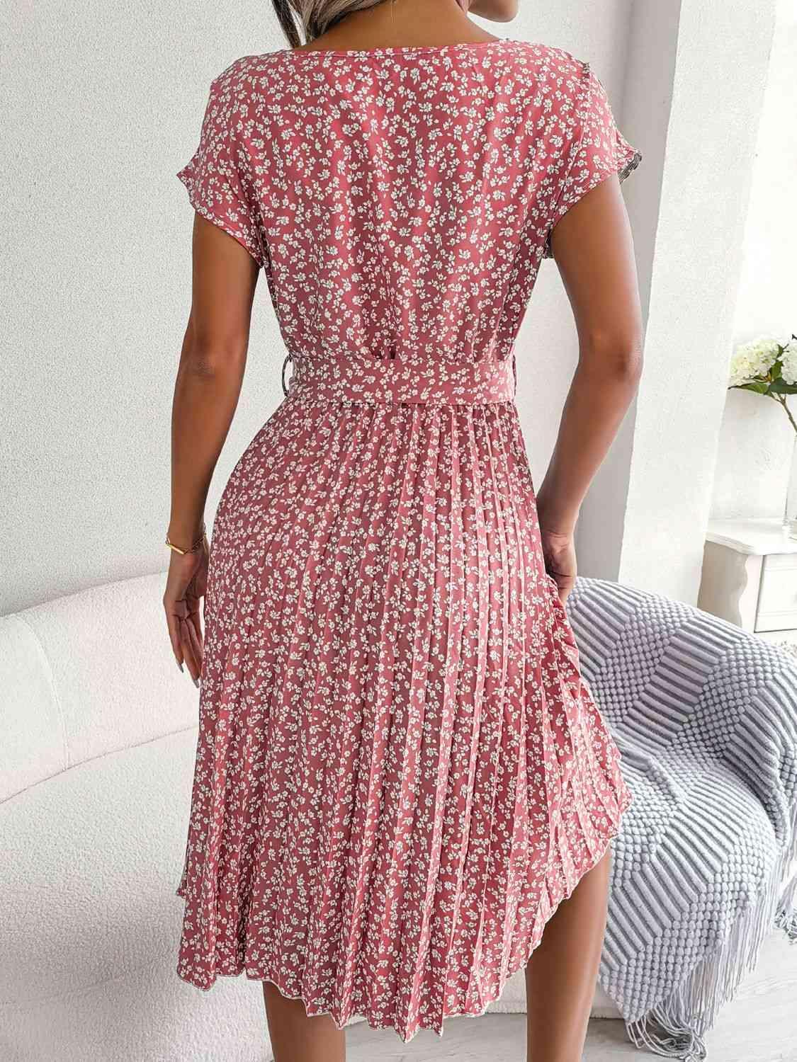 a woman in a red dress standing in a room