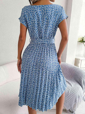 a woman in a blue dress standing in a room