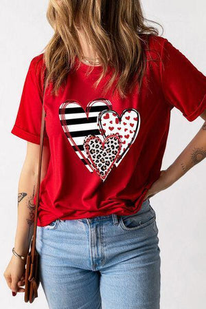 a woman wearing a red shirt with a heart on it