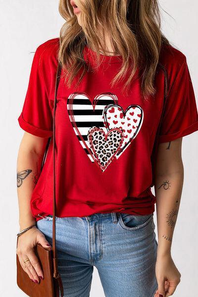 a woman wearing a red shirt with hearts on it