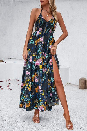 a woman wearing a floral print dress with a thigh high slit