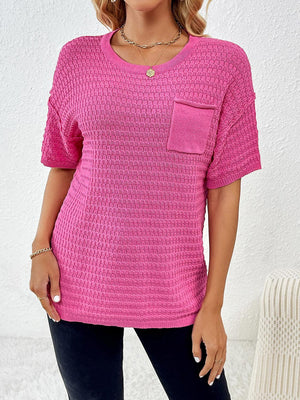 a woman wearing a pink top with a pocket