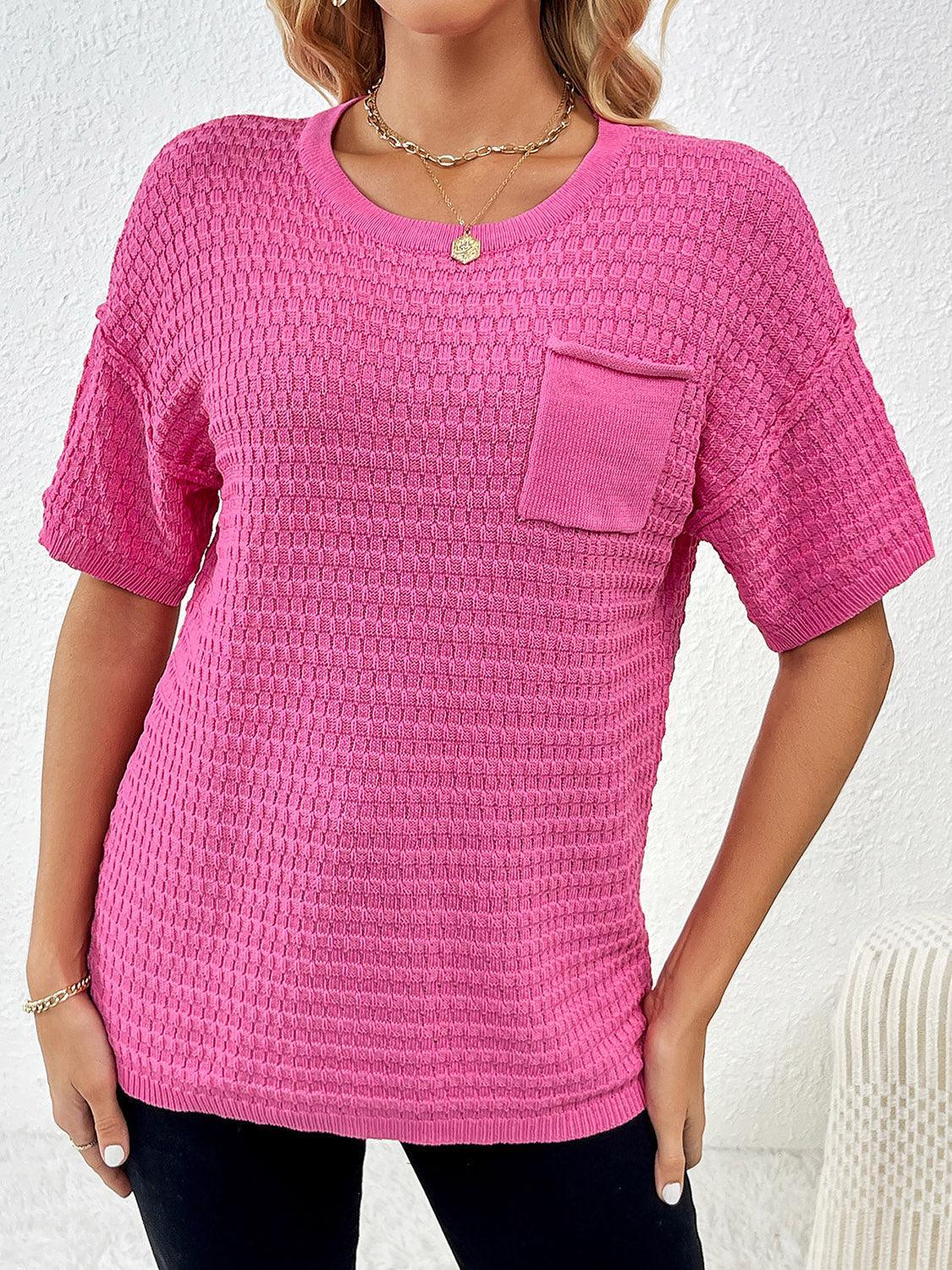a woman wearing a pink top with a pocket