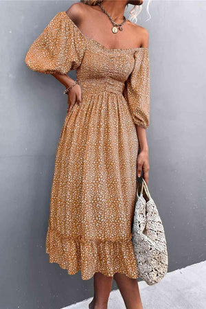 a woman wearing a brown floral print dress