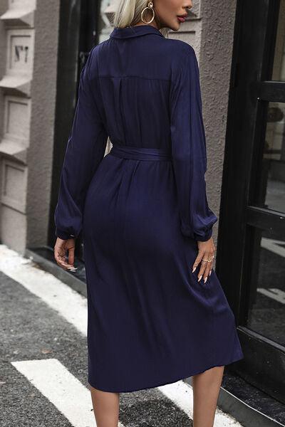a woman in a blue dress is walking down the street
