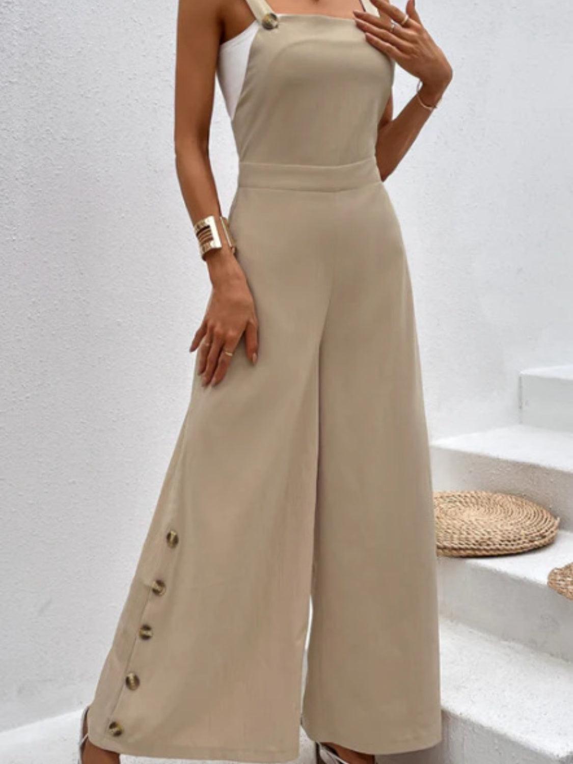 a woman wearing a tan jumpsuit with buttons on the side