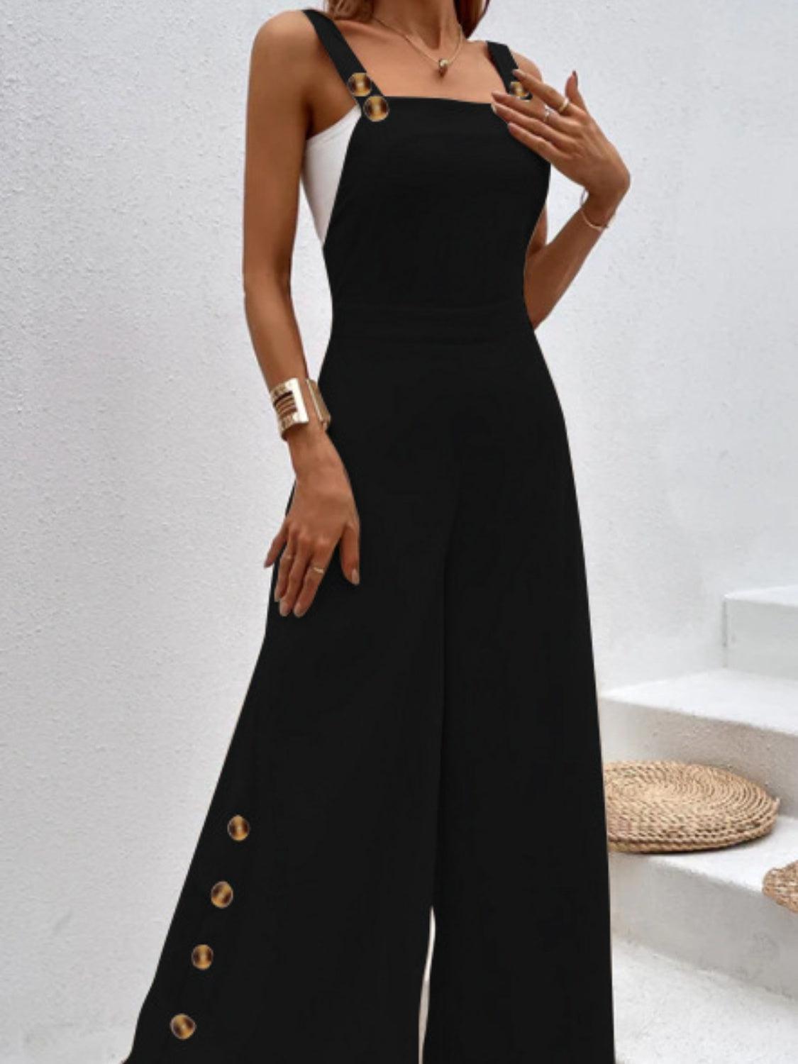 a woman wearing a black jumpsuit with gold buttons