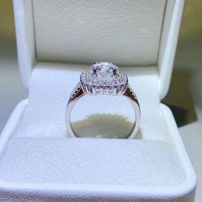 a diamond ring in a white box