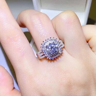 a close up of a person's hand holding a ring