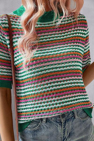 a woman wearing a green and pink striped sweater